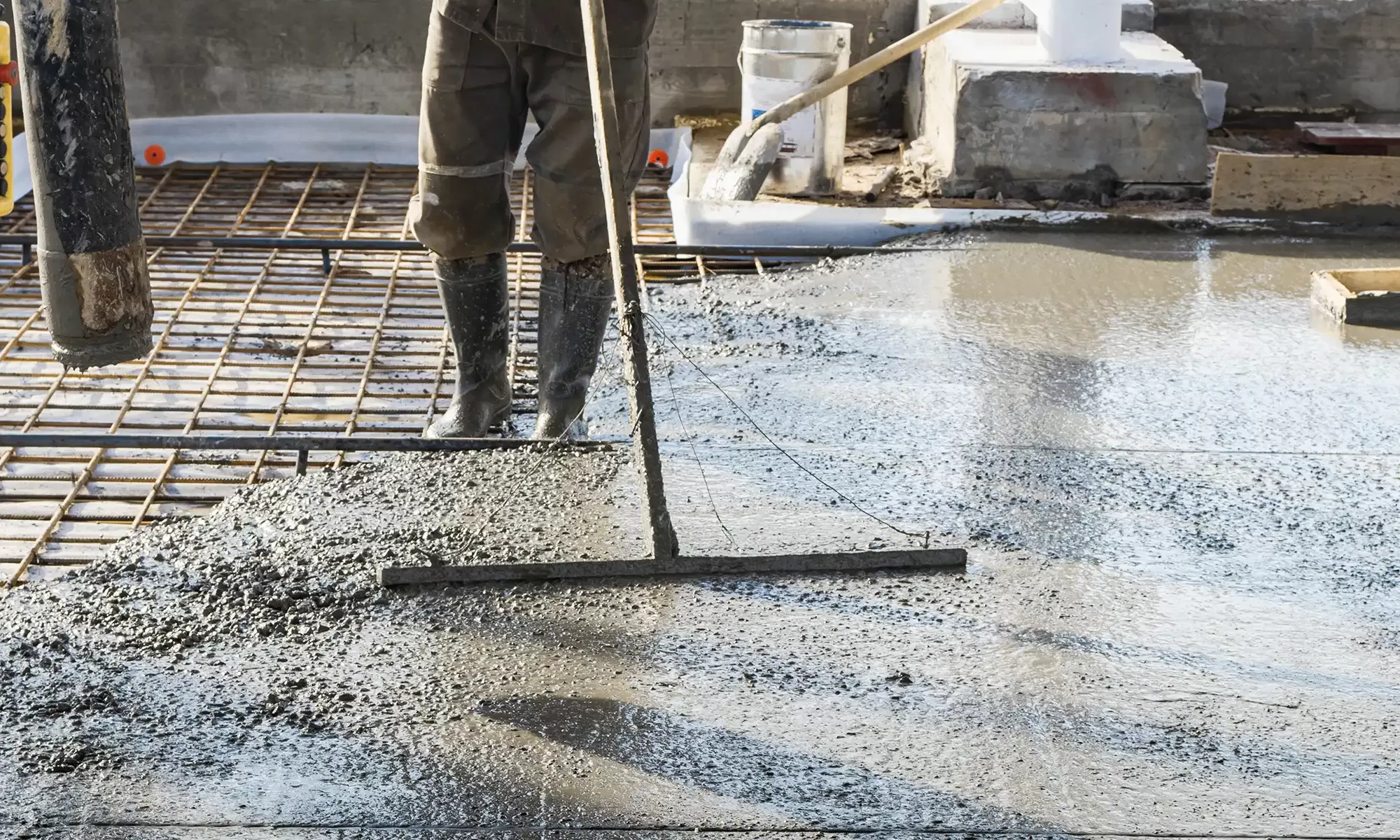 Workers smoothing the concrete mixture